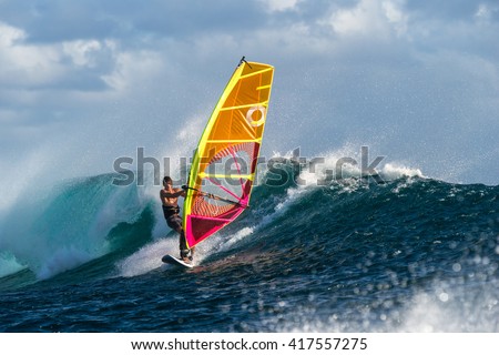 Windsurfer rides among the huge tubes and waves of the Indian Ocean on the island of Mauritius