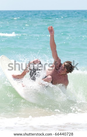a young surfer riding the waves in the sea spray