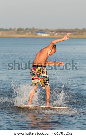 a young surfer riding the waves in the sea spray