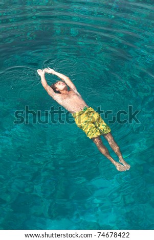 young man bathed in the turquoise water of the Red Sea