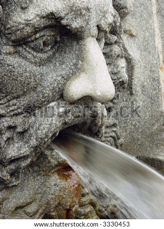 Fountain as a man\'s head pouring water from a mouth