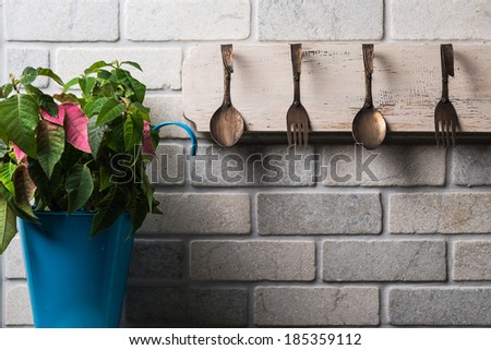 Kitchen wall with flowers and vintage hanger/Vintage kitchen wall/vintage kitchen wall hanger and flowers in blue pot
