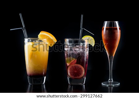 Cocktail glasses isolated on black / Cocktail bar glasses with cocktails on black background / Cocktail drinks in various glasses isolated