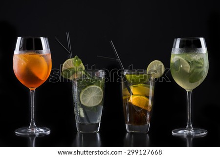 Cocktail glasses isolated on black / Cocktail bar glasses with cocktails on black background / Cocktail drinks in various glasses isolated