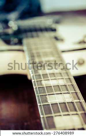 Closeup of an Electric guitar fretboard. Focus on the foreground