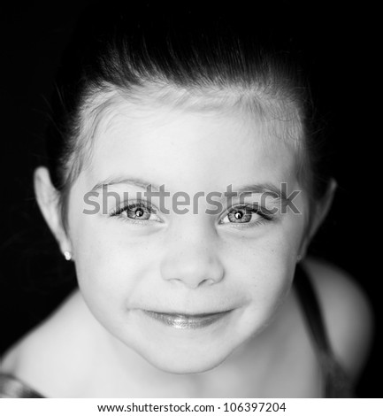 High key image of a beautiful toddler ballerina on white background