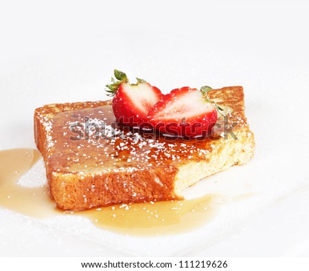 French toast with syrup and strawberries