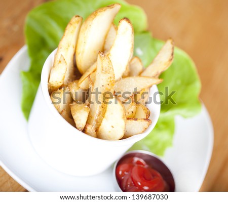 Potato Wedges on plate served with ketchup