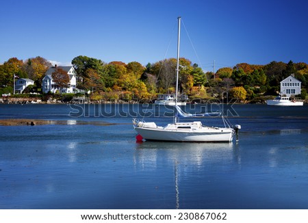 Beautiful sailboat in harbor on a clear autumn day