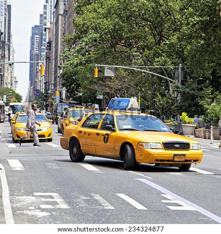 New York City - June 28th, 2014:Yellow Taxi traveling down the street in New York City, NY on June 28th, 2014.