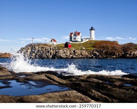 Nubble lighthouse with rough splashing waves