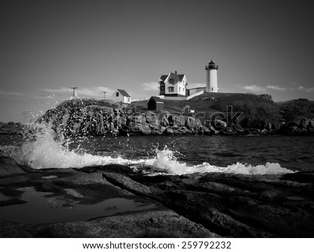 Nubble lighthouse with rough splashing waves