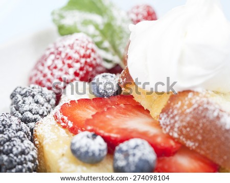 Pound cake with fruit and a whipped topping. Shallow depth of field