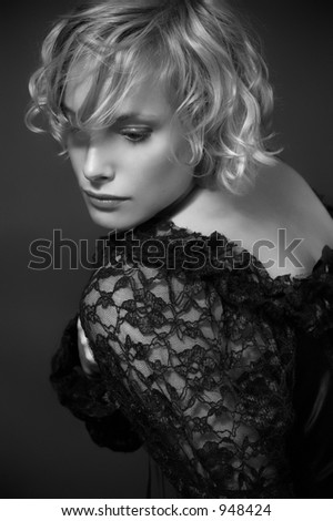 Portrait of the elegant woman in a lacy black blouse. It is black a white photo