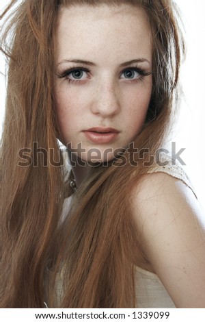 stock photo : A girl with red hair and freckles. The photo is made in