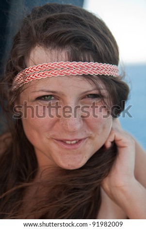 Portrait of a smiling girl with a ribbon in her hair
