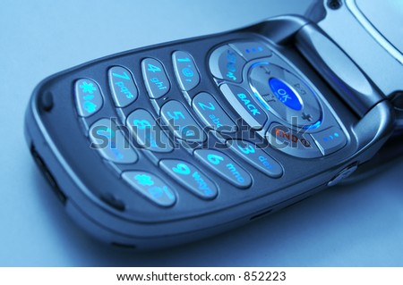 A cell phone key pad with cool blue lighting.