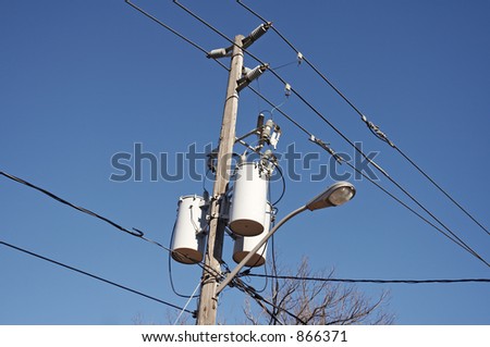A telephone pole with a street light.