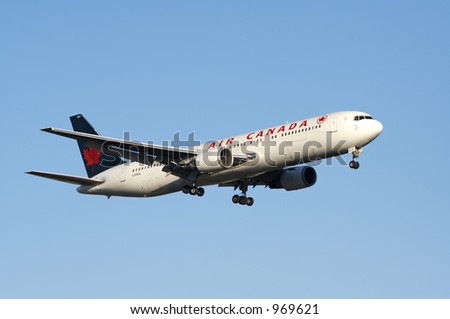 An Air Canada aircraft coming in for landing with it\'s gears down.