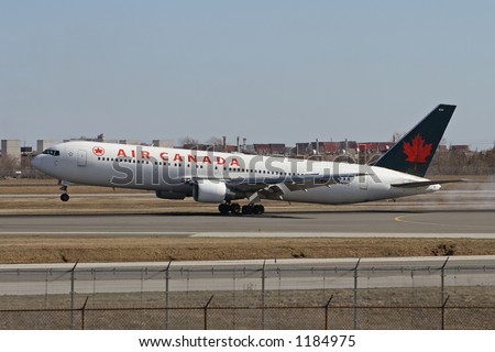 An Air Canada aircraft landing on the runway.