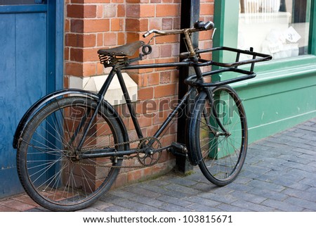 Old Victorian Bicycle Standing Outside A Victorian Shop Window.