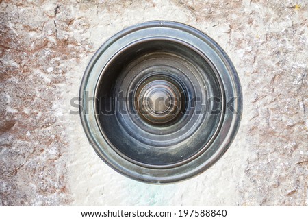 Vintage pull door/house bell on textured brickwork background.