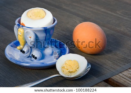 Boiled eggs in  eggcups on an old wooden table