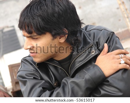 portrait of a young indian man wearing leather jacket - stock photo portrait of a young indian man wearing leather jacket - stock photo
