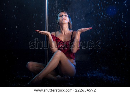 Young sexy woman pole dancer. Water studio photo