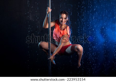 Young sexy woman pole dancer. Water studio photo