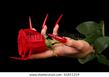 Human fingers with long fingernail and beautiful manicure isolated on black
