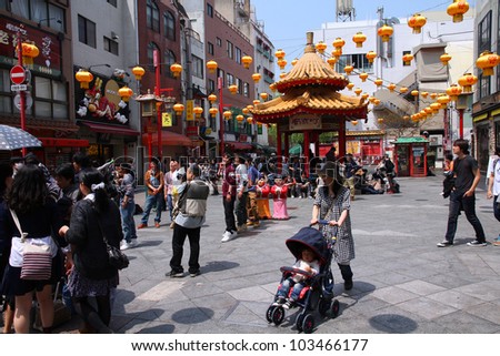 KOBE, JAPAN - APRIL 24: Visitors enjoy sunny weather in Chinatown station on April 24, 2012 in Kobe, Japan. Nankinmachi, Kobe\'s Chinatown is the 2nd largest in Japan and a popular tourism attraction.