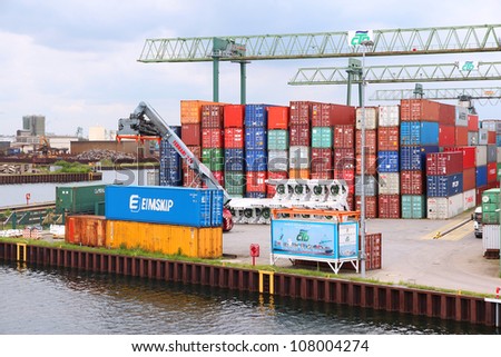 DORTMUND, GERMANY - JULY 16: Containers are loaded in Dortmund Port on July 16, 2012 in Germany. It is the largest canal port in Europe and had shipped almost 3 million tons of freight in 2007.