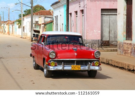 REMEDIOS, CUBA - FEBRUARY 20: Man drives old American car on February 20, 2011 in Remedios, Cuba. New change in law allows Cubans to trade cars. Cars in Cuba are very old because of the old law.