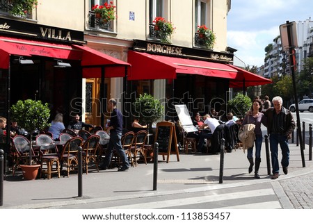 PARIS - JULY 24: Tourists walk past Villa Borghese cafe on July 24, 2011 in Paris, France. Paris is the most visited city in the world with 15.6 million international arrivals in 2011.