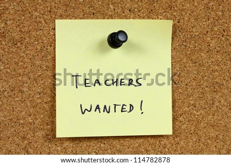 Teachers wanted - education career opportunity. Job recruitment. Yellow sticky note pinned to an office notice board.