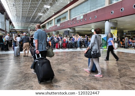 TENERIFE, SPAIN - NOVEMBER 2: Passengers hurry on November 2, 2012 in Tenerife South Airport, Spain. With 8.7m passengers in 2011 it was busiest airport in Tenerife and 7th busiest in Spain.