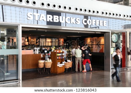 Malaga, Spain - October 14: People Visit Starbucks Coffee On October 14, 2010 At Malaga Airport, Spain. With 17,800 Stores It Is Largest Coffeehouse Company Worldwide.