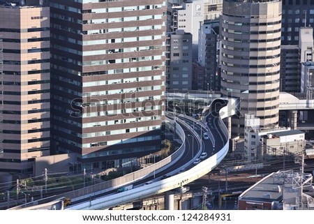 OSAKA, JAPAN - APRIL 27: Cars ride through Gate Tower Building on April 27, 2012 in Osaka, Japan. The building is extremely popular because of highway crossing through it.