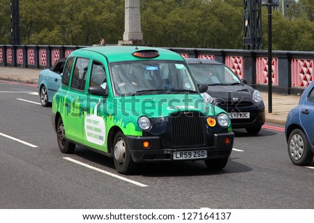 LONDON - MAY 13: Taxi cab drives on May 13, 2012 in London, England. As of 2012, there were 24,000 licensed taxi cabs in London.