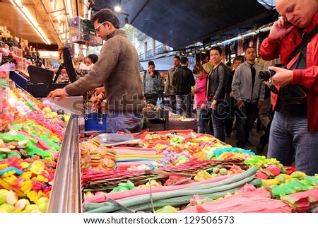 BARCELONA, SPAIN - NOVEMBER 6: People visit Boqueria market on November 6, 2012 in Barcelona, Spain. Tripadvisor says it is best shopping destination in Barcelona, the most visited city in Spain.