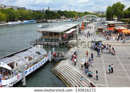 PARIS - JULY 25: Tourists walk along river Seine on July 25, 2011 in Paris, France. Paris is the most visited city in the world with 15.6 million international arrivals in 2011.