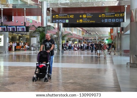 TENERIFE, SPAIN - NOVEMBER 2: Passengers hurry on November 2, 2012 in Tenerife South Airport, Spain. With 8.7m passengers in 2011 it was busiest airport in Tenerife and 7th busiest in Spain.