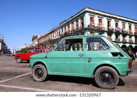 HAVANA - JANUARY 30: People walk past old Fiat 126 car on January 30, 2011 in Havana. Recent change in law allows the Cubans to trade cars again. Most cars in Cuba are very old because of the old law.
