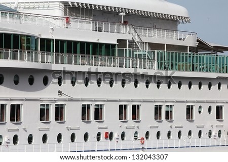 Side view on a huge white cruise ship. Vacation travel.