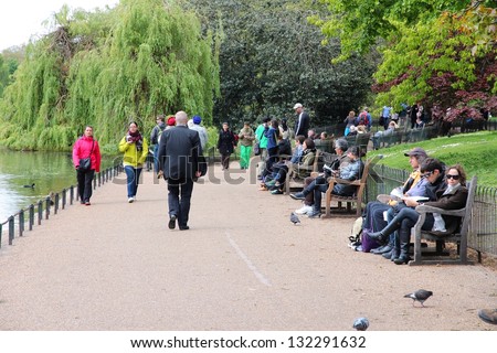LONDON - MAY 16: Tourists walk in St. James\'s Park on May 16, 2012 in London. With more than 14 million international arrivals in 2009, London is the most visited city in the world (Euromonitor).