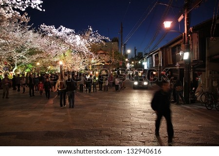 KYOTO, JAPAN - APRIL 14: Visitors enjoy night cherry blossom (sakura) on April 14, 2012 in Gion district, Kyoto, Japan. Old Kyoto is a UNESCO World Heritage Site and one of top tourism places in Japan