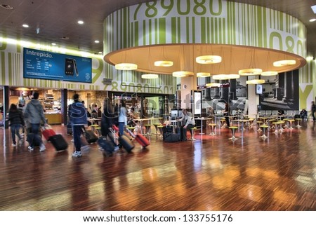 BERGAMO, ITALY - OCTOBER 21: Travelers hurry in the airport terminal on October 21, 2012 in Bergamo, Italy. Bergamo Airport had 8.9m passengers in 2012 and is one of fastest growing airports in Italy.