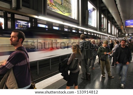 PARIS - JULY 20: People wait at Paris Metro station on July 20, 2011 in Paris, France. Paris Metro is the 2nd largest underground system worldwide by number of stations (300).