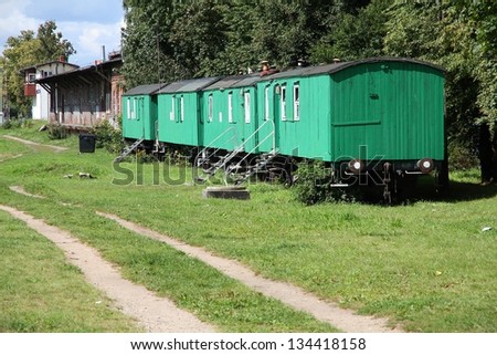 Living in old train cars - vintage wooden train carriages made into homes in Poland countryside.